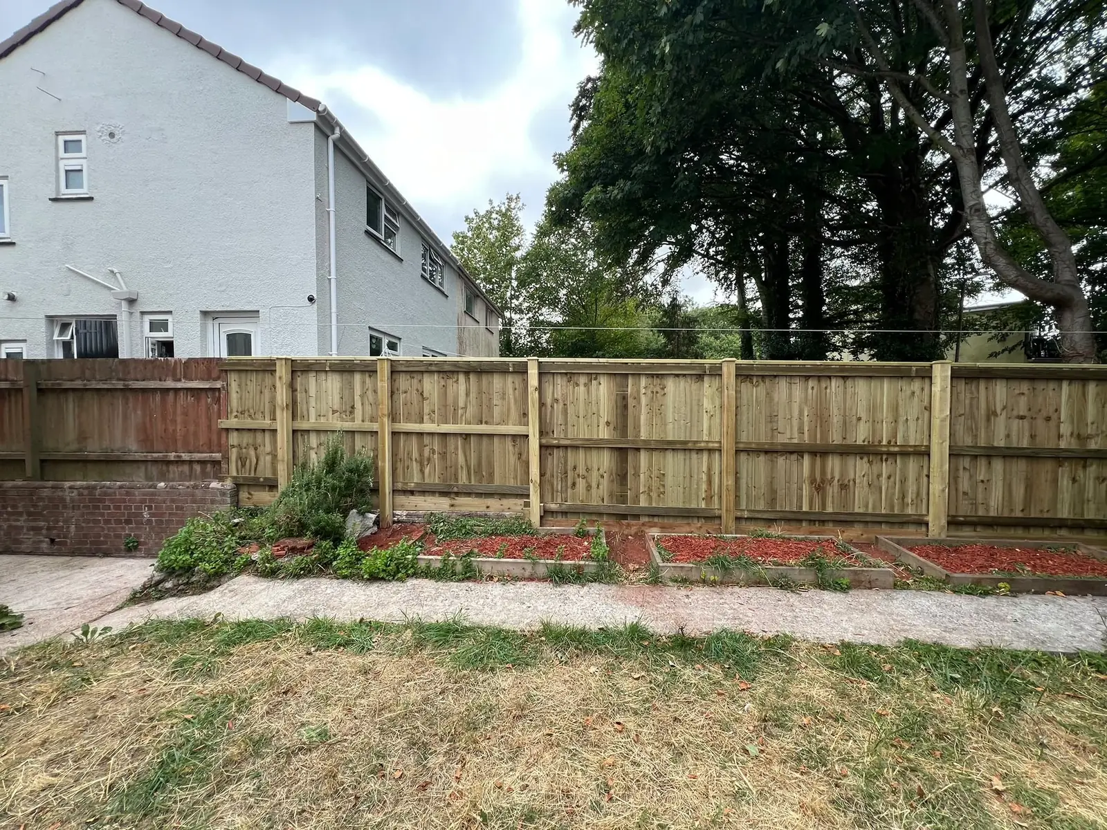 New posts and gravel boards set in place, forming the foundation of a durable fence.