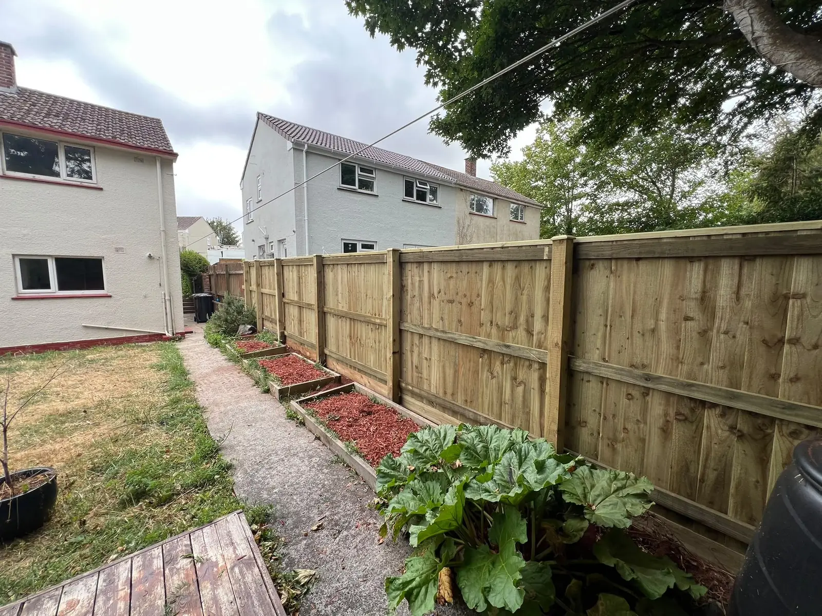 The overlapping feather-edge boards create a solid, private boundary with no gaps.