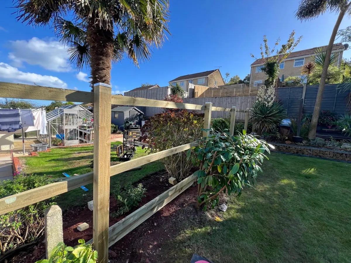 New timber posts, rails and gravel board for a 6ft featherboard fence in Brixham, with an original concrete post left in place