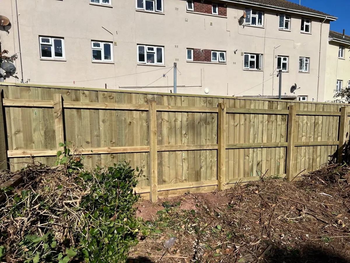 Garden side of a new 6ft featherboard fence in Torbay showing timber posts and three horizontal rails