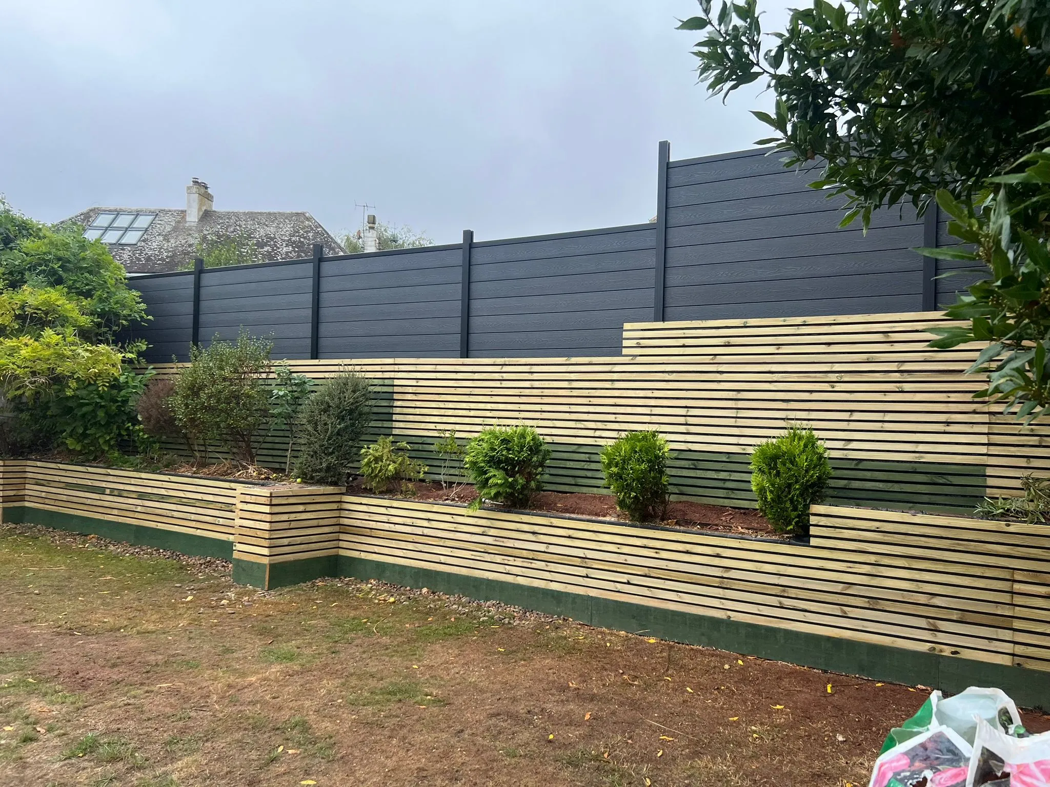 The continuous timber screen elevation seen from the lawn.